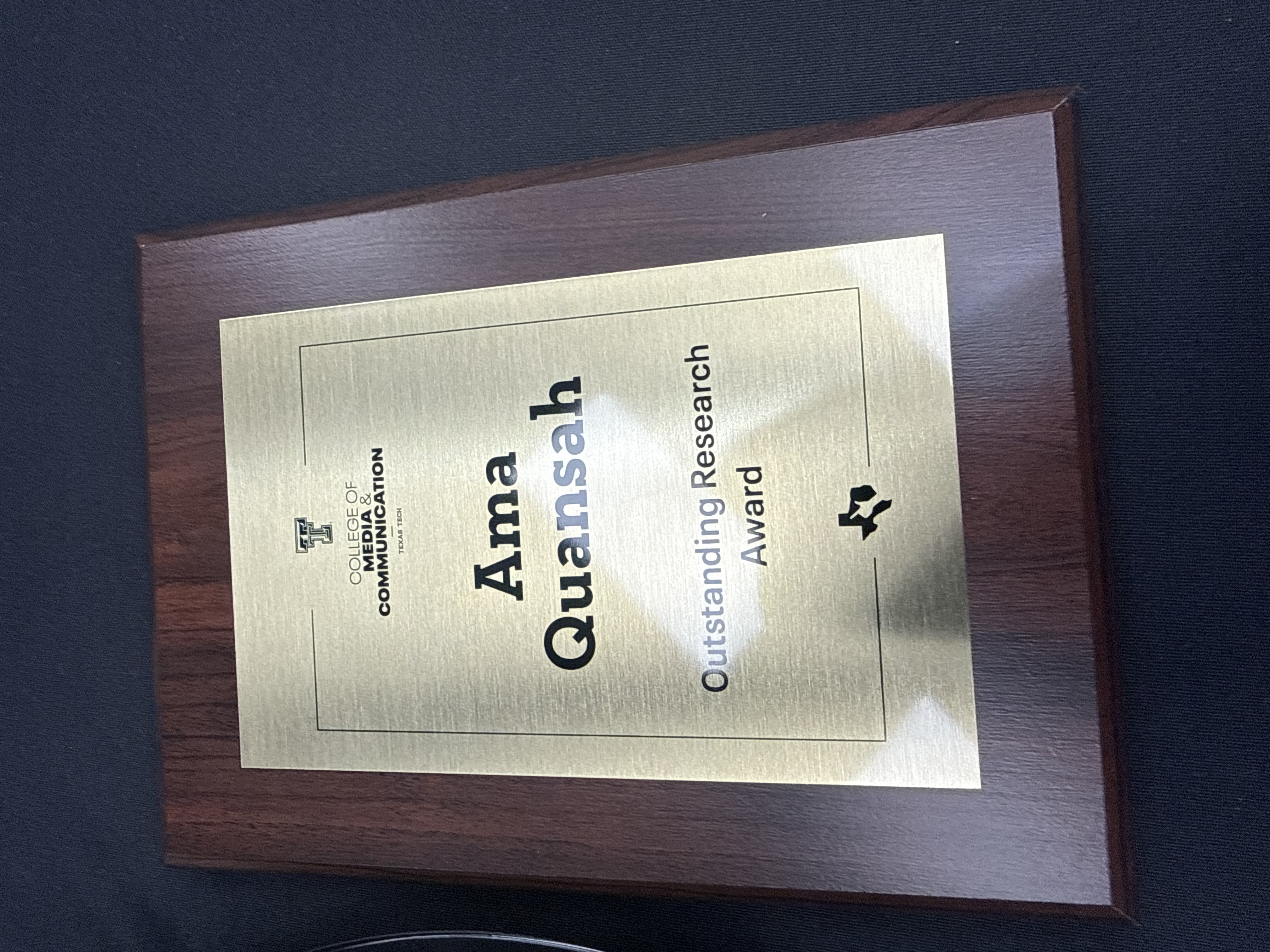 Outstanding Research Award plaque received from the TTU Department of Communication Studies, Spring 2026